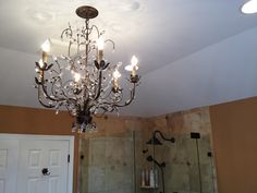 a chandelier hanging from the ceiling in a bathroom