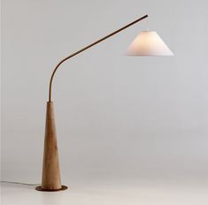 a wooden lamp with a white shade on it's head and a light bulb attached to the base