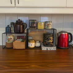 a kitchen counter with various items on it and a coffee pot sitting on top of the table