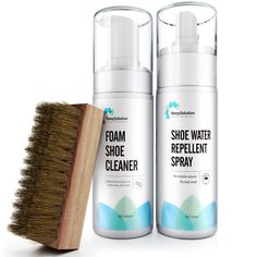 two bottles of shoe water next to a wooden brush on a white background with the same product in front of it