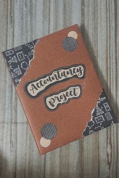 a brown book sitting on top of a wooden table