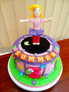 a cake that has a girl on top of it with the words summer spelled out