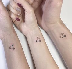 three wrist tattoos with stars, moon and sun on each one arm in black ink