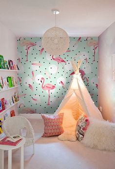 a bedroom with a teepee tent and pink flamingos on the wall