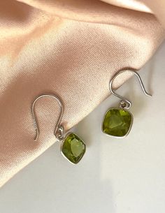 Item Specifications Handmade Sterling Silver Gemstone: Peridot Stone: Cubic Zirconia CZ Total carat weight : Approx 4.72tcw Treat yourself or your loved one with these beautiful peridot earrings. Light and easy to wear all day long! Material : Sterling Silver 925  Gemstones : Peridot Gemstone Shape: Cushion Gemstone Size : 8x8mm Earring Closure: French Ear Wire Availability ------------------ *Limited Quantity* Country of Manufacture ------------------- *USA Michigan* Ready To Ship Shop at Gabriana Jewelers with confidence. We've been in jewelry making business for over 35 years.Each and every one of our items are made with special care by a skilled professional, and we guarantee all our customers satisfaction. Customers would come to us with very rough ideas ,even drawn on a sticky note , Sterling Silver Lime Green Gemstone Jewelry, Lime Green Sterling Silver Gemstone Jewelry, Lime Green Gemstone Jewelry In Sterling Silver, Silver Peridot Drop Earrings, Fine Jewelry Peridot Earrings As Gift, Fine Jewelry Peridot Earrings For Gift, Elegant Peridot Dangle Earrings, Elegant Peridot Earrings With Ear Wire, Silver Peridot Earrings For May Birthstone