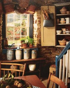 an old fashioned kitchen with lots of pots and pans