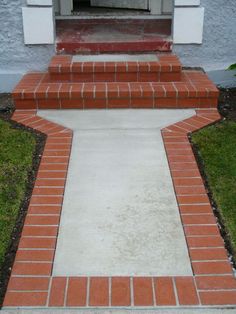 a cat is sitting on the front steps of a house