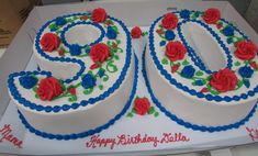 a birthday cake decorated with roses and the number 50 on it's side is ready to be eaten