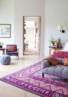 a living room filled with furniture and lots of windows