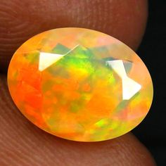 an opalite is being held in someone's hand, with it's fingers