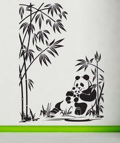 a panda bear sitting in the grass next to a tree and bamboo trees wall decal