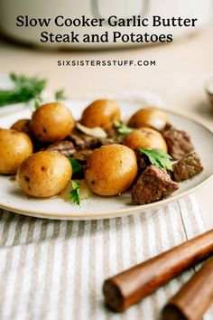 slow cooker garlic butter steak and potatoes on a plate with parsley garnish