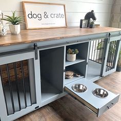 a dog and crate stand with two bowls on it