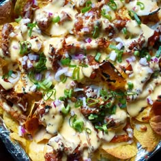 nachos covered in cheese, onions and green peppers