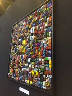 there is a large display of cars on the wall