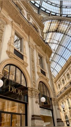 the inside of a building with many windows and glass roofing on it's sides