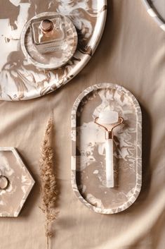 the table is set with two plates and a silver tray on it, along with a small plant