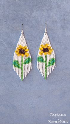 "These handmade unique earrings \"Sunflower\" are made of high-quality Czech beads and strong synthetic thread. I use my author's scheme . They are elegant, fashionable, and highly versatile, suitable for everyday wear. Color: white,yellow,brown,green . Copy without my permission is prohibited For those who want to buy my copyright scheme for these earrings: https://www.etsy.com/uk/listing/1056785837/brick-stitch-pattern-for-seed-bead?ref=shop_home_active_2 100% hand made with love! Measurements White Flower-shaped Jewelry With Sunflower Design, White Flower Jewelry With Sunflower Design, White Sunflower Design Flower Jewelry, White Flower-shaped Jewelry With Dangling Beads, White Beaded Earrings For Summer Gift, Bohemian Sunflower Design Jewelry With Round Beads, Sunflower Dangle Earrings For Summer, Bohemian Summer Jewelry With Sunflower Design, Summer White Beaded Earrings Gift