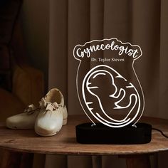 a pair of shoes sitting on top of a wooden table next to a glass plaque