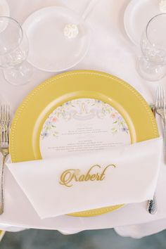 A gold plate with a custom floral print menu and a white napkin with the name "Robert" written in gold. French Bulldog Ring Bearer, Romantic Wedding Inspiration, Decor Plants, Sparkler Send Off, Wedding Petals, Pastel Wedding, Event Services