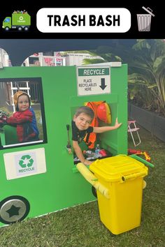 a young boy standing in front of a trash can with the words trash bash on it