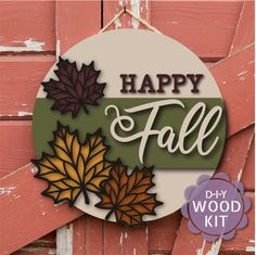 a sign that says happy fall hanging on the side of a wooden door with leaves