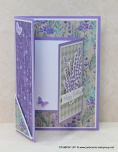 an open card with purple flowers and butterflies on it