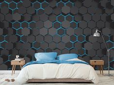 a bedroom with black and blue hexagonal wallpaper