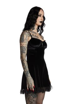 will have them under the illusion of devotion. You're like a prayer in this impure velvet mini dress that has sinful lace trim, underwire support, a deathly devoted cross design and back zip closure. Black Gothic Mini Dress With Lace Trim, Gothic Lace Trim Mini Dress For Halloween, Halloween Gothic Mini Dress With Lace Trim, Gothic Halloween Mini Dress With Lace Trim, Gothic Mini Dress With Lace Trim For Night Out, Gothic Mini Dress With Corset Back, Gothic Underbust Dress For Night Out, Fitted Gothic Velvet Dress For Costume Party, Fitted Gothic Velvet Mini Dress