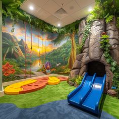 a children's playroom with a slide, climbing wall and jungle scene painted on the walls