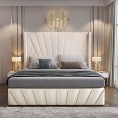 a large white bed sitting in a bedroom on top of a hard wood floor