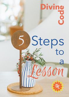 a wooden sign sitting on top of a table next to a vase filled with flowers