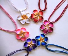 four necklaces with flowers painted on them