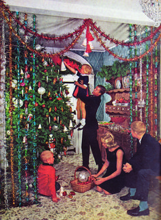 a group of people decorating a christmas tree