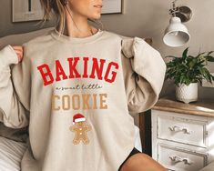 Are you looking for a trendy pregnancy Christmas sweatshirt for yourself or for someone you love? If that's the case, you're in the right place. This cute sweater, with a cute baking design, is meant to put a smile on your face every time you wear it and to help you deliver the great news of a baby on the way in a much jollier way. If you know someone who is pregnant and loves wearing Christmas themed clothes, this sweatshirt would make a great present for her.  Check out more pregnancy themed d Baking Design, Christmas Pregnancy Announcement, Christmas Pregnancy, Cute Baking, Create Picture, Pregnancy Reveal, Presents For Her, Baby On The Way, Pregnancy Reveals