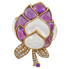 A beautiful brooch with beautiful amethyst stones and mother-of-pearl sitting closely together. Forty four diamonds are set in the leaf design. The metal is 18k yellow gold, gross weight 55.5 grams. Measurements: L: 2.5 in (6.5 cm) W: 1 3/4 in (4.5 cm) Amethyst Stones, Gold Pin, The Leaf, Mother Pearl, Amethyst Stone, Modern Jewelry, Leaf Design, Mother Of Pearl, Brooch Pin