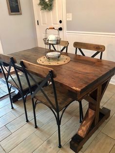 a wooden table with four chairs around it