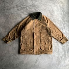 Vintage 'Filson' Tin Cloth Linen Hunter Jacket  - USA - Size 42 (look on measurements) - Condition: need wash and rewax, small holes on the lining on the cuffs (photo incl.)  Measurements : cm/in * chest 64/25.2 * length 79/31.1 * sleeve length 51/20.08 * hem 64/25.2  Questions? fill free to ask * no refund !IMPORTANT! information about delivery: fill free to ask about express delivery before order   * Please note that all clothes which I sell are vintage or used and may have signs of imperfecti Winter Khaki Sport Coat With Patch Pockets, Rugged Fall Outerwear With Buttons, Rugged Fall Sport Coat For Hunting, Vintage Sport Coat With Double-needle Stitching For Fall, Vintage Fall Sport Coat With Double-needle Stitching, Classic Hunting Outerwear With Flap Pockets, Classic Khaki Outerwear With Button Cuffs, Rugged Sport Coat With Flap Pockets For Winter, Rugged Winter Outerwear With Patch Pockets