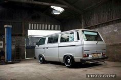 an old silver van parked in a garage