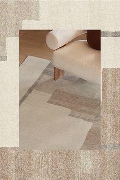 a chair sitting on top of a wooden floor next to a rug covered in squares