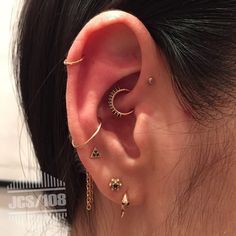 an ear with three different piercings attached to it