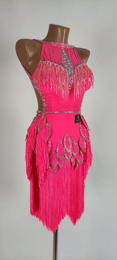 a pink dress with fringes and beads on it