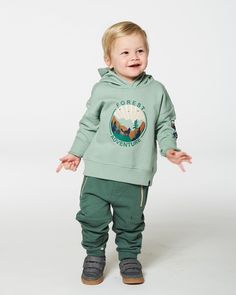 Our Hooded Fleece Sweatshirt with Print Sage is a must-have for the boy who's always ready for an adventure! This pullover sweatshirt is made from soft and cozy cotton/poly fleece and features long sleeves, an attached hood, and rib knit trim at the cuffs and hem. Outdoorsy graphic prints on the chest and sleeve make it a playful addition to any little boy's wardrobe! Long sleeve hooded sweatshirt Pullover silhouette Graphic print on chest and sleeves 80% Cotton, 20% Polyester Fits true to size Short Rain Boots, Blanket Sweater, Fleece Sweatshirt, The Boy, Set Outfit, Winter Accessories, Shop Swimwear, Pullover Sweatshirts, Baby Month By Month