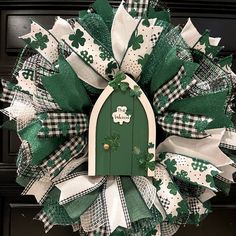 a green and white wreath with shamrocks on it