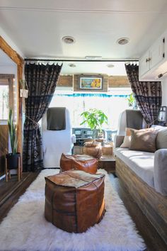 a living room with two couches and a rug in front of the window,