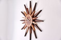 a wooden clock is hanging on the wall