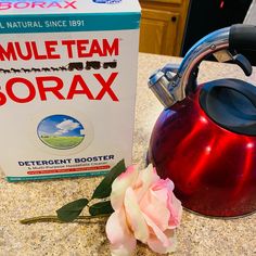 a red tea kettle next to a box of borax