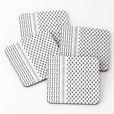 four black and white coasters on a white surface