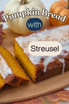 pumpkin bread with streusel on a cutting board next to fall leaves and pumpkins