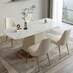 a dining room table with chairs and a vase filled with flowers on top of it